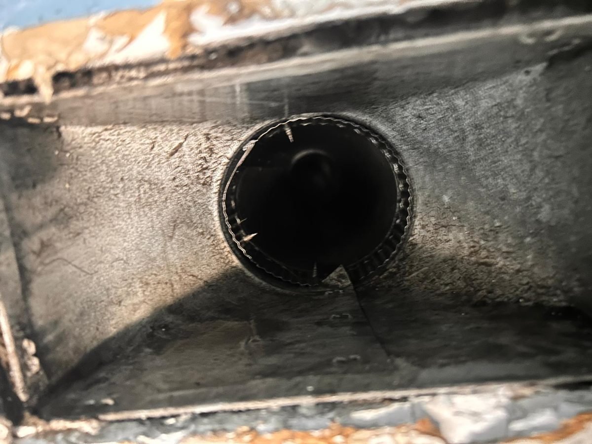 Wall vent box with dark buildup around the duct opening